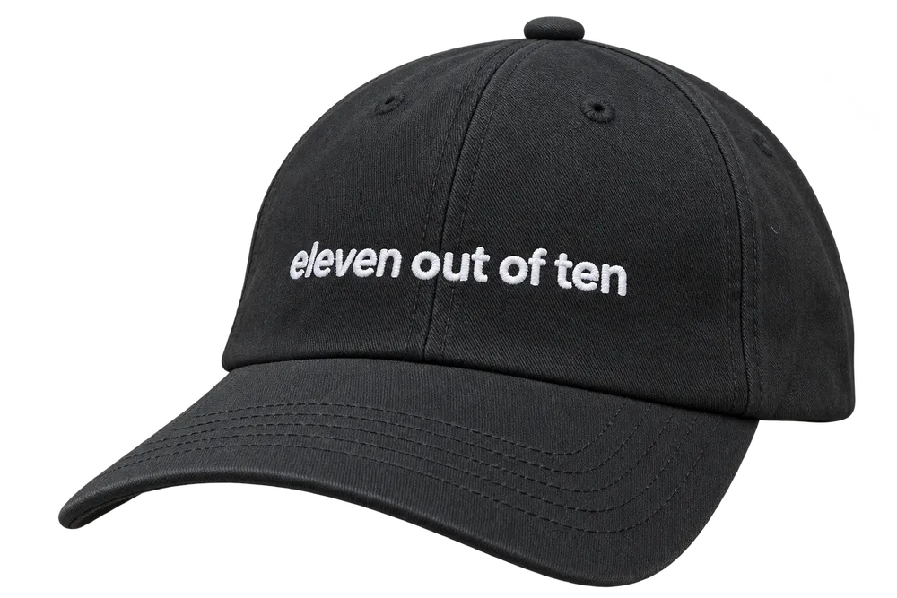 Black ElevenLabs cap with "eleven out of ten" embroidered in white across the front